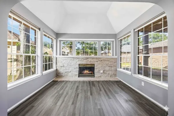 a living room with a fireplace and windows