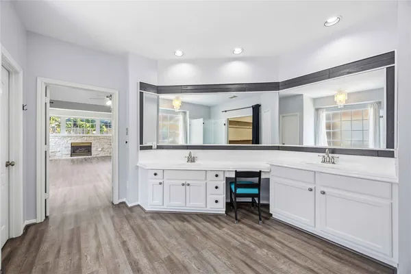a spacious bathroom with a double vanity sink and a mirror