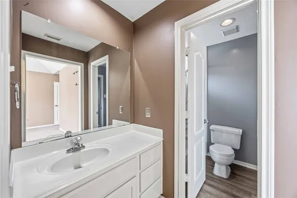 a bathroom with a toilet a sink and a mirror