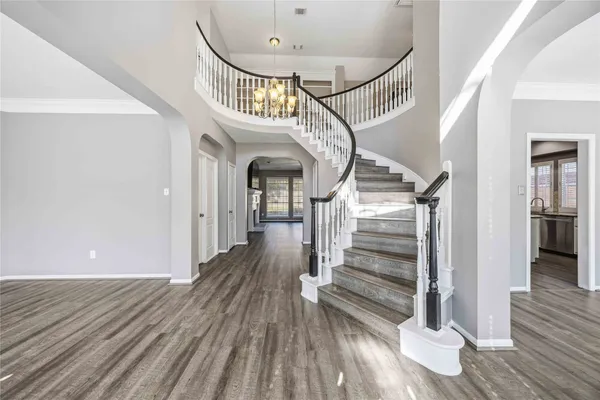 a view of entryway and hall with wooden floor