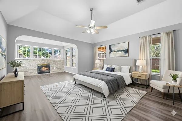 a spacious bedroom with a large bed couch and a window