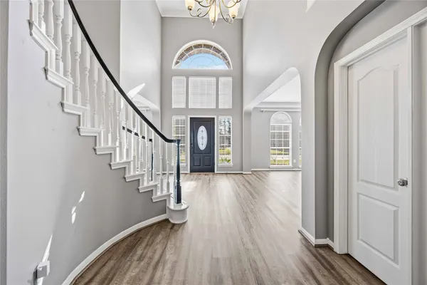 a view of entryway and hall with wooden floor