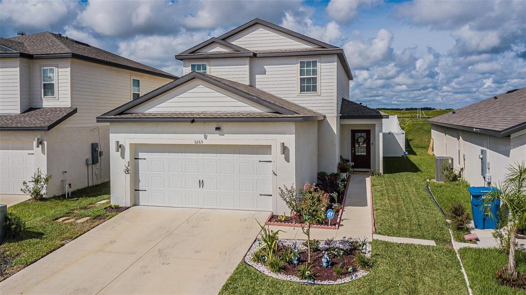 5265 Cricket Hill Road Brooksville, FL 34602 - Photo 1 of 30 a front view of a house with a yard and garage