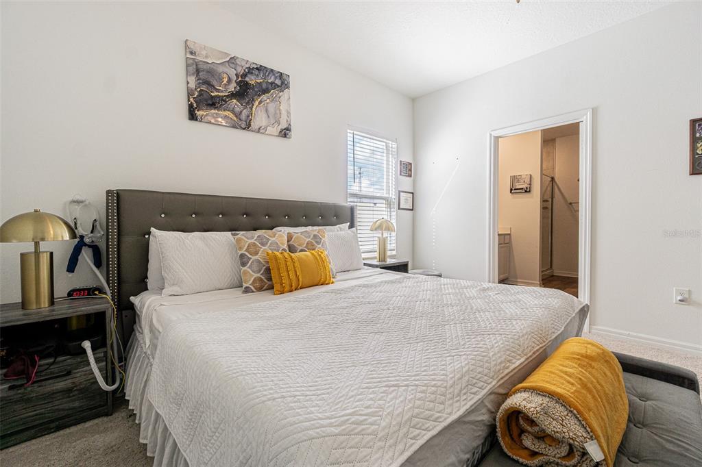 5265 Cricket Hill Road Brooksville, FL 34602 - Photo 18 of 30 a bedroom with a bed and wooden floor