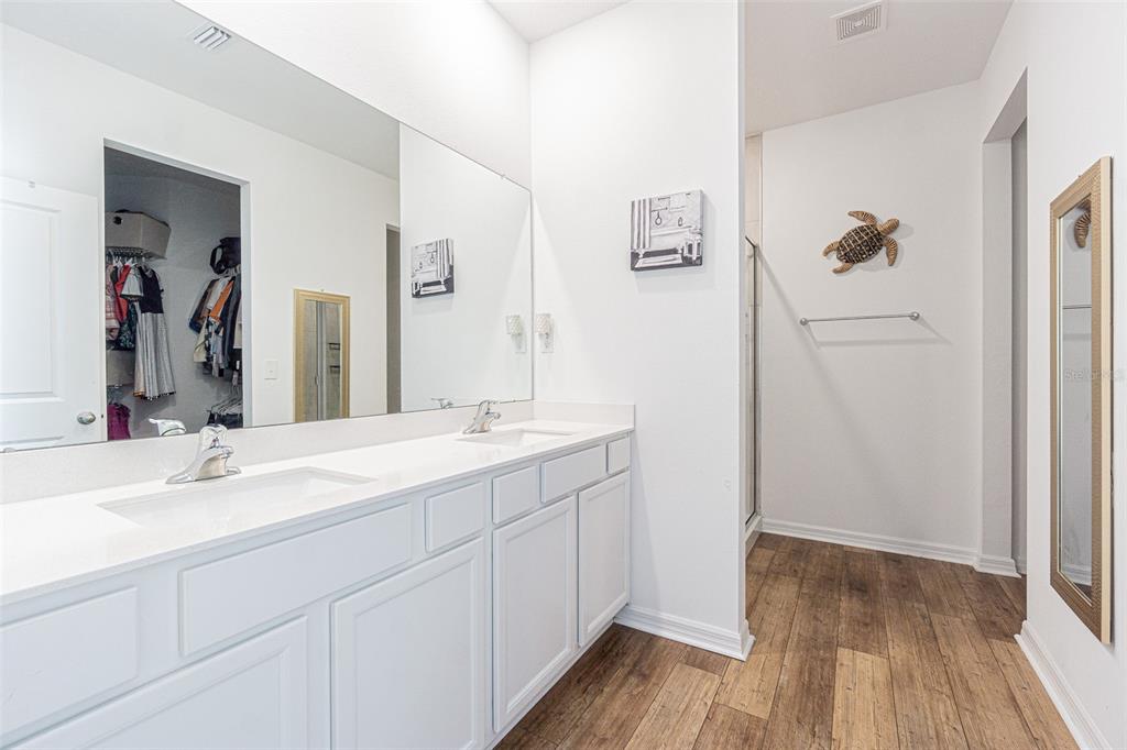 5265 Cricket Hill Road Brooksville, FL 34602 - Photo 19 of 30 a bathroom with a double vanity sink and mirror