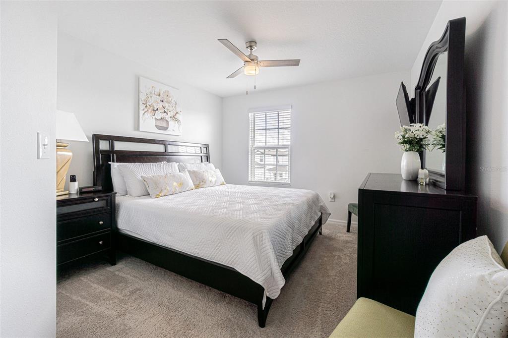 5265 Cricket Hill Road Brooksville, FL 34602 - Photo 25 of 30 a bedroom with a bed and a chandelier