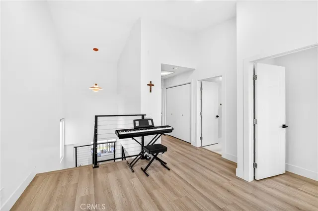 a view of a room with wooden floor table and chairs