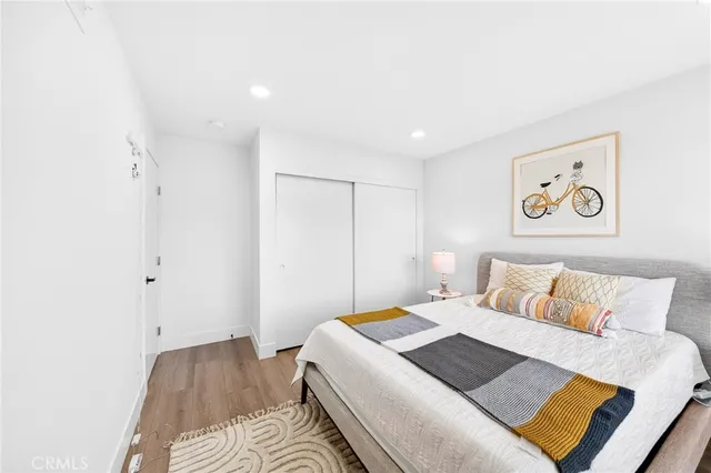 a bedroom with a bed and a painting on the wall