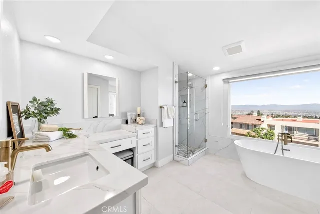 a bathroom with a tub sink and mirror