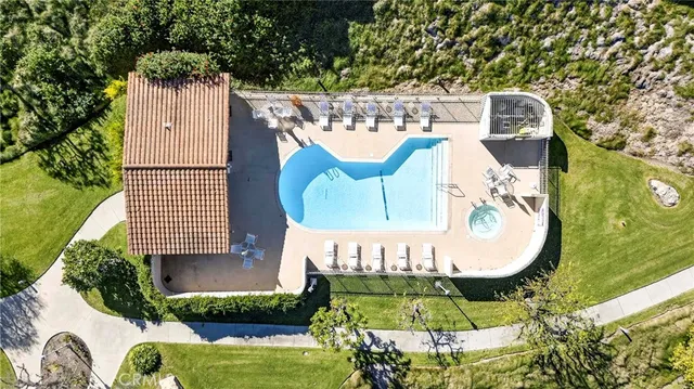 an aerial view of a house with swimming pool garden and outdoor seating