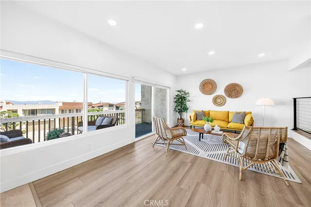 a living room with furniture and a floor to ceiling window