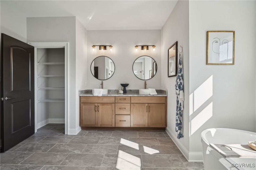 16873 Watchman Way Beaverdam, VA 23015 - Photo 20 of 40 a spacious bathroom with a toilet a sink and a mirror