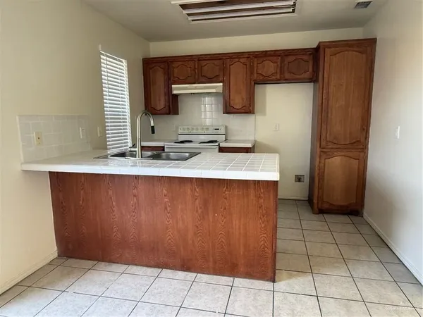 a kitchen with stainless steel appliances a sink and a refrigerator