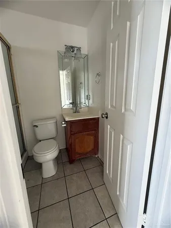 a bathroom with a toilet a sink and a mirror