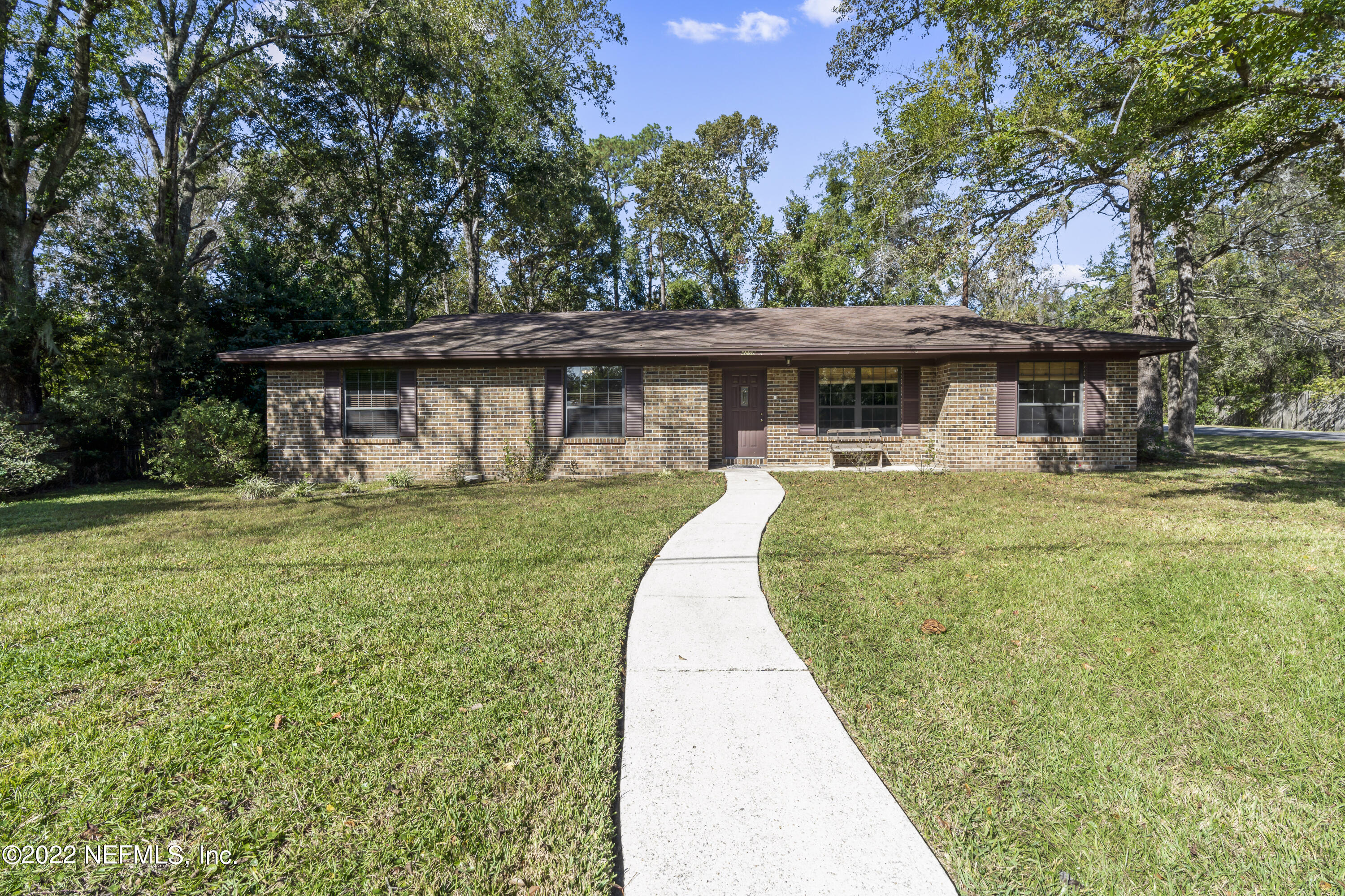 4208 Cedar Road Orange Park, FL 32065 - Photo 1 of 37 a front view of a house with garden