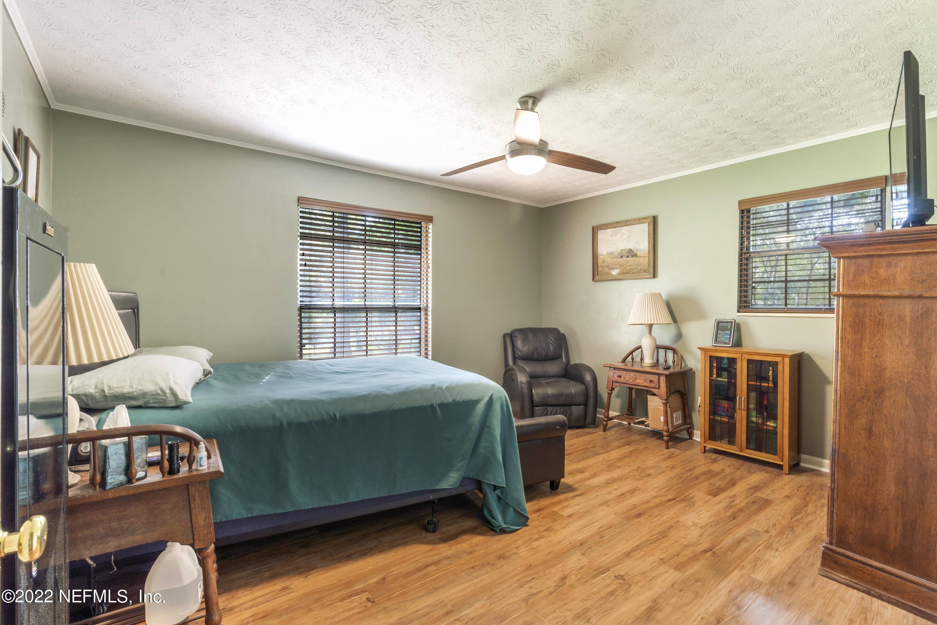 4208 Cedar Road Orange Park, FL 32065 - Photo 22 of 37 a bedroom with a bed and a chandelier
