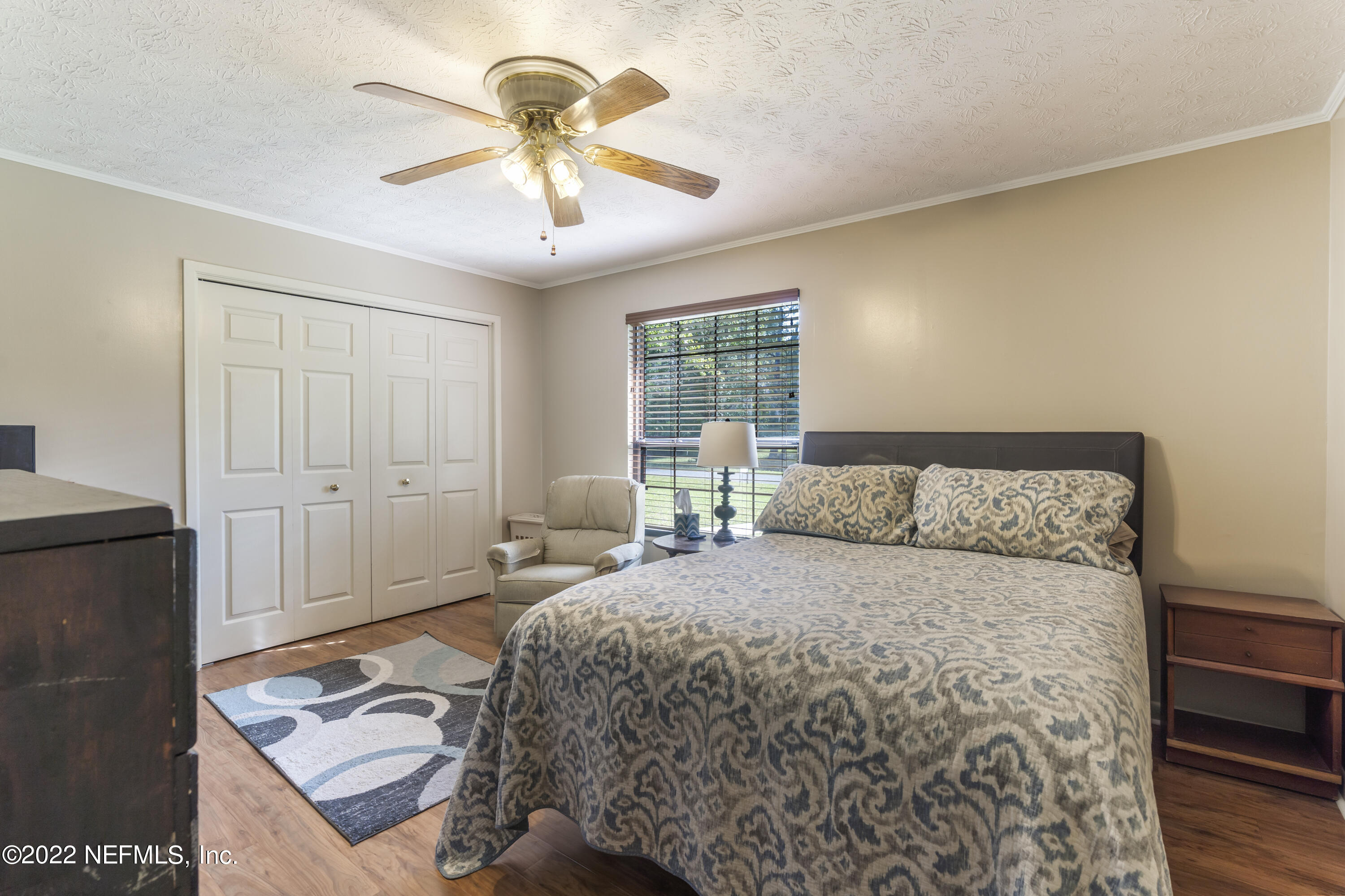 4208 Cedar Road Orange Park, FL 32065 - Photo 23 of 37 a bedroom with a bed and a chandelier