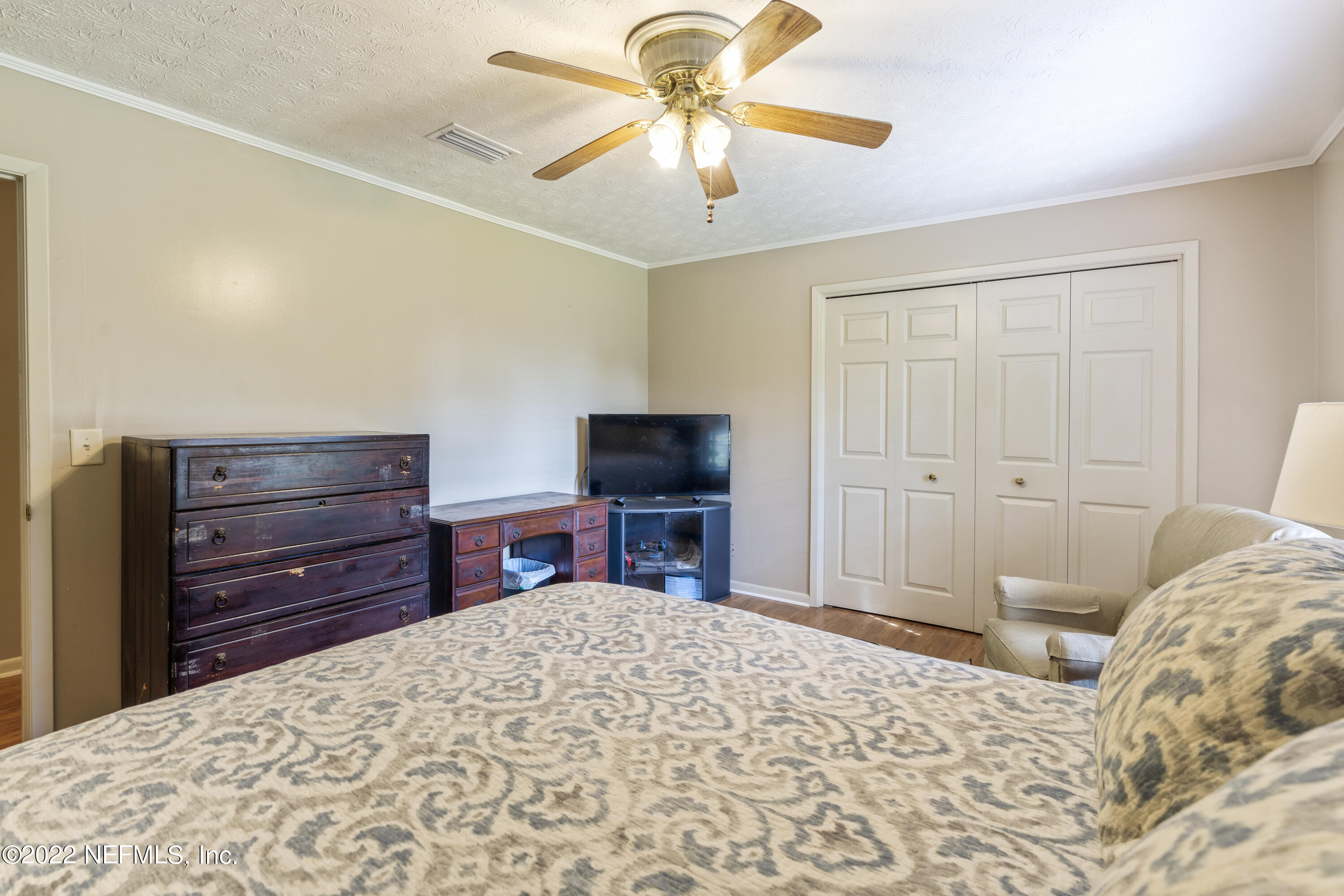4208 Cedar Road Orange Park, FL 32065 - Photo 24 of 37 a bedroom with a bed and a chandelier