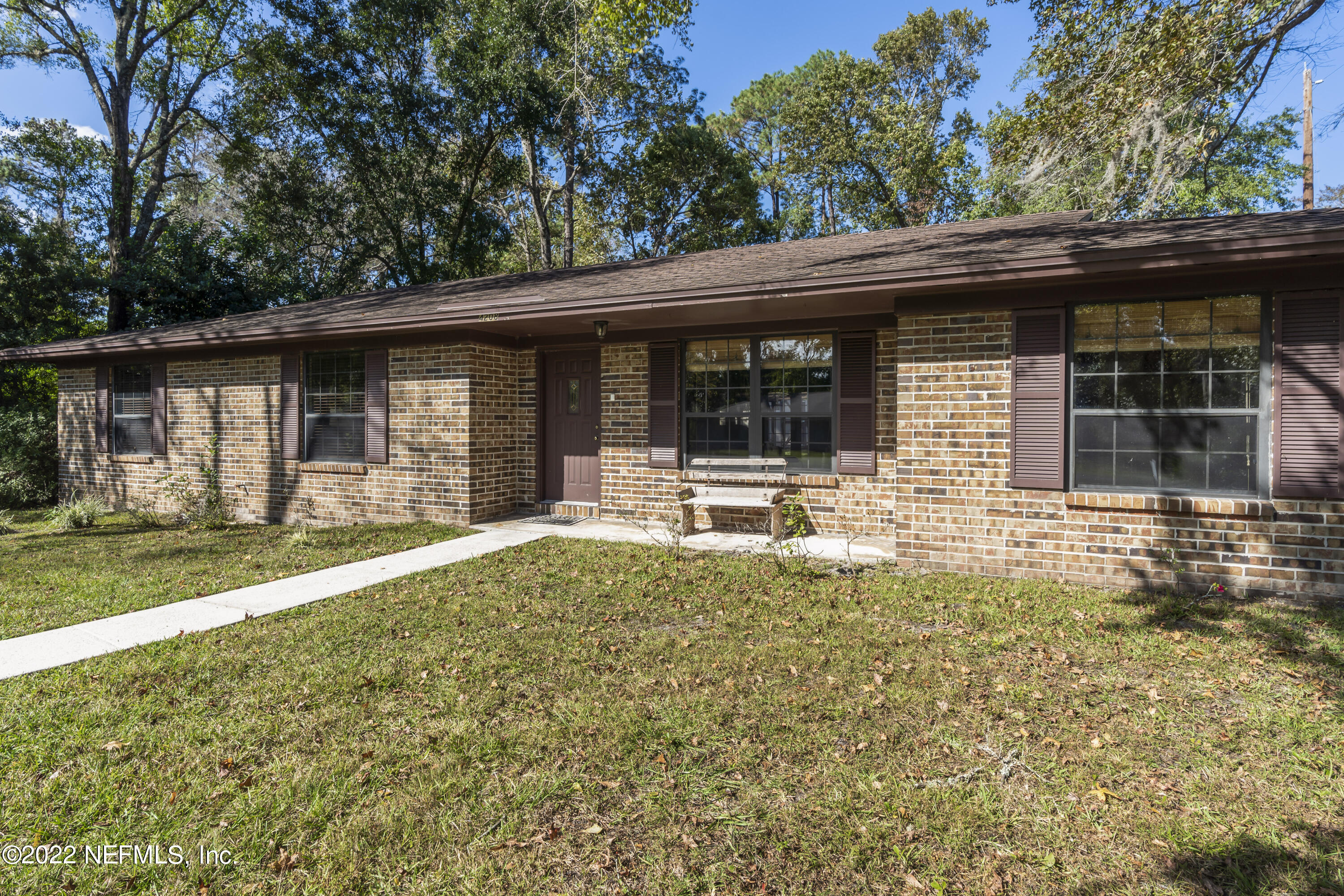 4208 Cedar Road Orange Park, FL 32065 - Photo 36 of 37 a backyard of a house with yard and outdoor seating