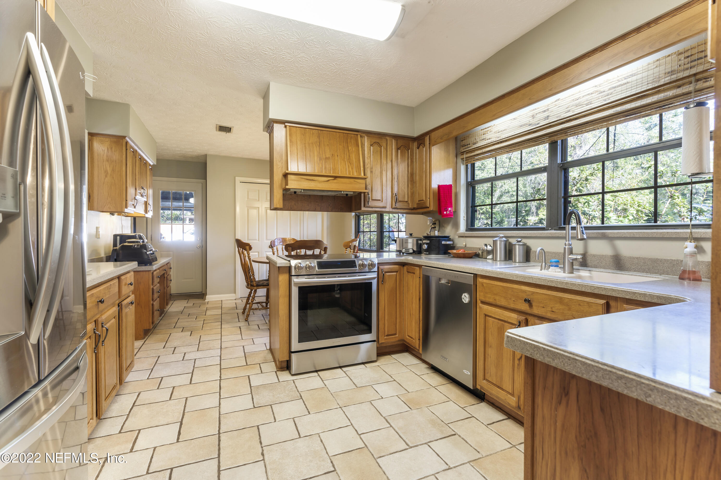 4208 Cedar Road Orange Park, FL 32065 - Photo 10 of 37 a kitchen with stainless steel appliances granite countertop a refrigerator and a sink