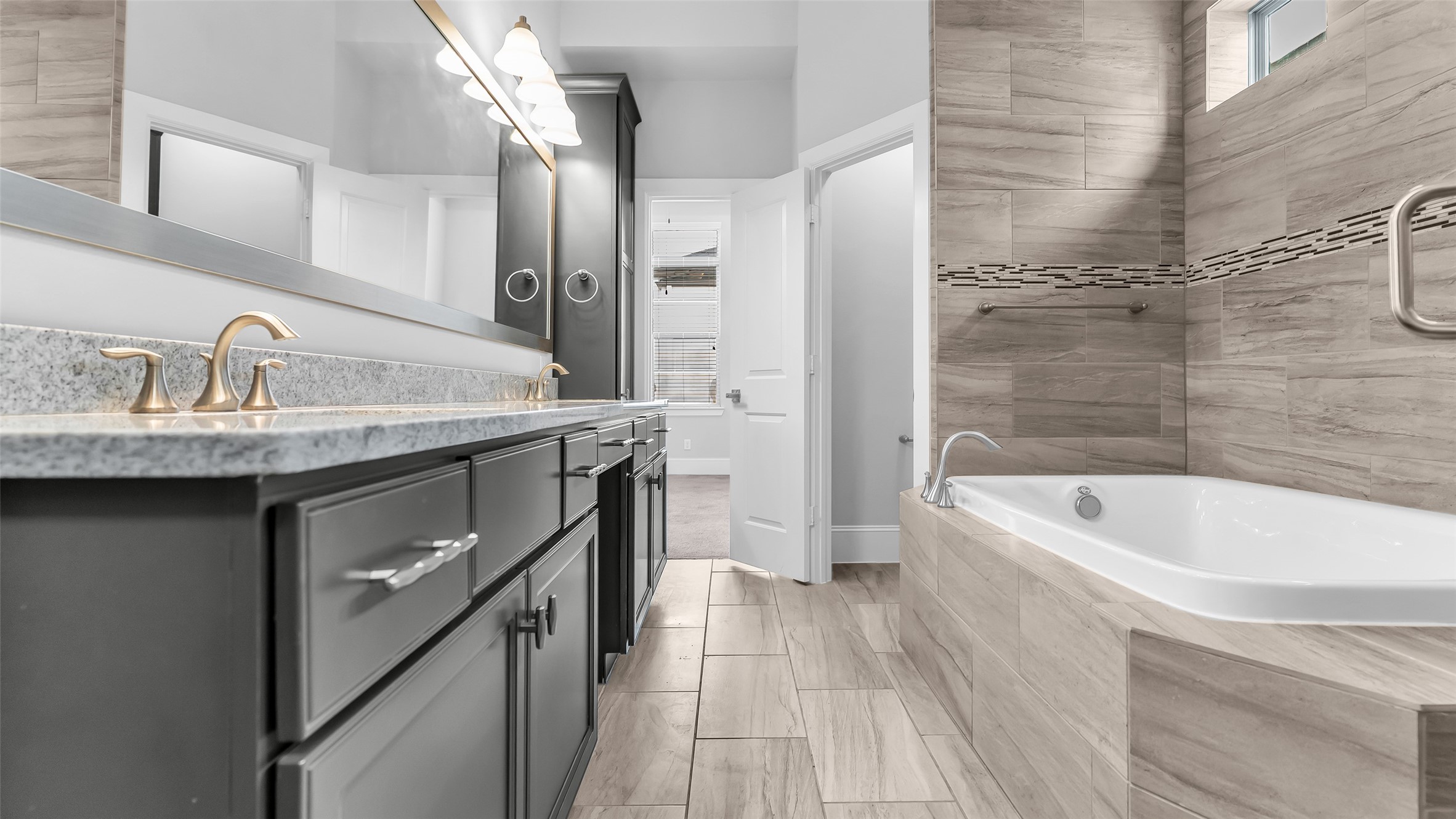 5429 Larkin Street Houston, TX 77007 - Photo 39 of 47 a bathroom with a granite countertop bathtub sink vanity and toilet