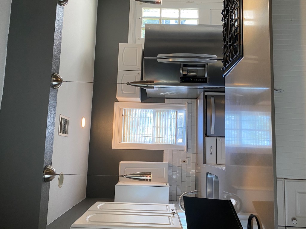 3804 Duval Street Austin, TX 78751 - Photo 11 of 21 a kitchen with stainless steel appliances granite countertop a sink and a refrigerator