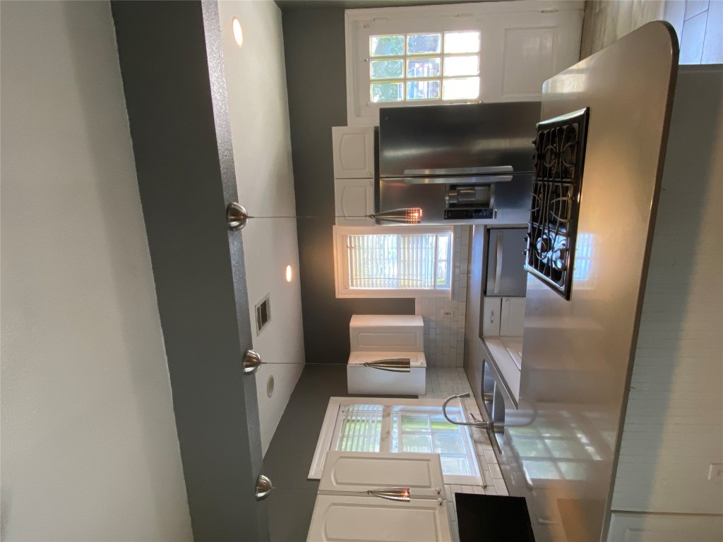 3804 Duval Street Austin, TX 78751 - Photo 12 of 21 a kitchen with stainless steel appliances granite countertop a sink stove and refrigerator