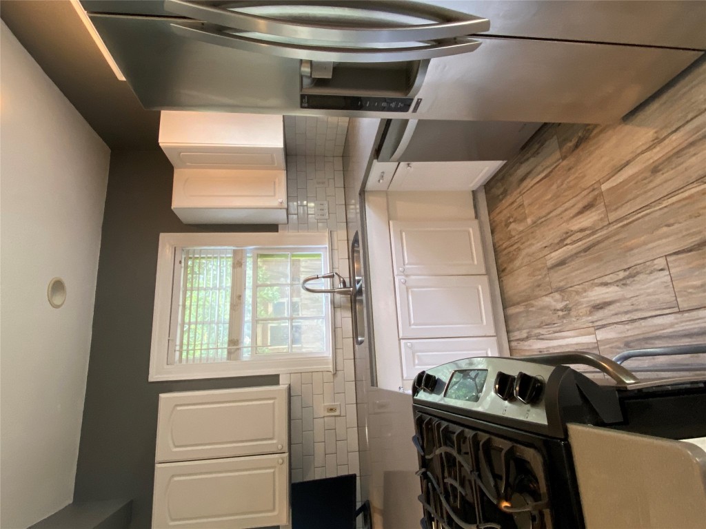 3804 Duval Street Austin, TX 78751 - Photo 14 of 21 a white kitchen with sink and stainless steel appliances