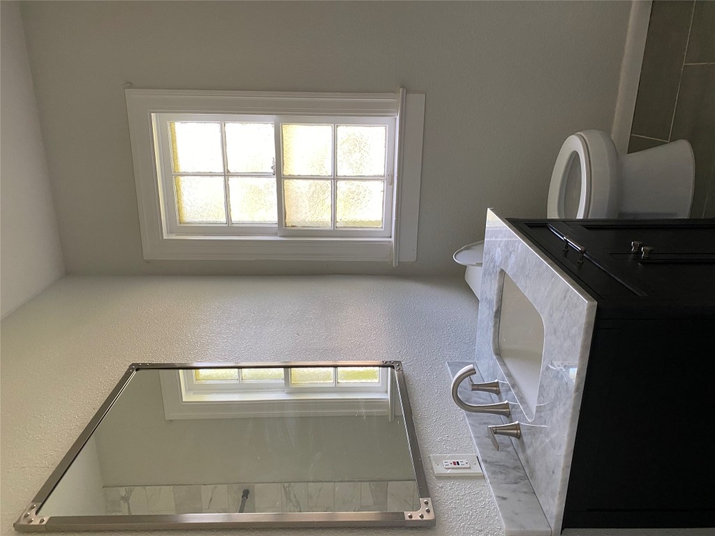 3804 Duval Street Austin, TX 78751 - Photo 16 of 21 a bathroom with a granite countertop sink toilet and mirror