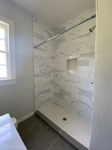 a bathroom with a glass shower door