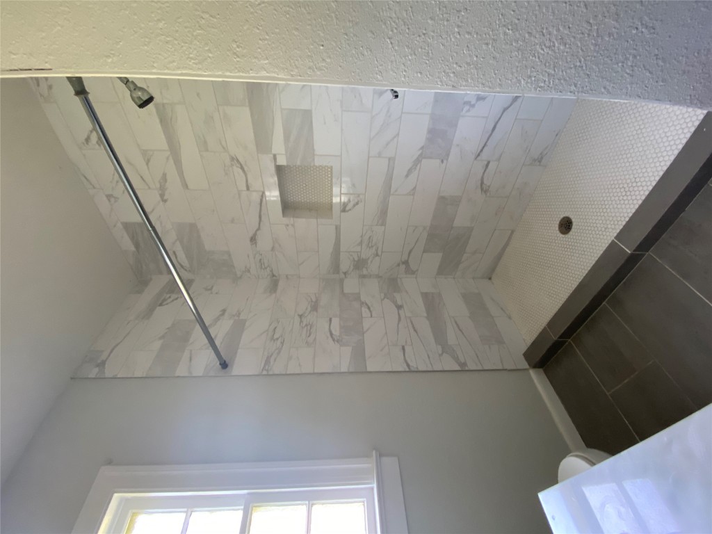 3804 Duval Street Austin, TX 78751 - Photo 17 of 21 a bathroom with a glass shower door