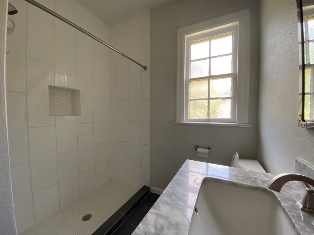 3804 Duval Street Austin, TX 78751 - Photo 19 of 21 a bed sitting in a bedroom next to a window