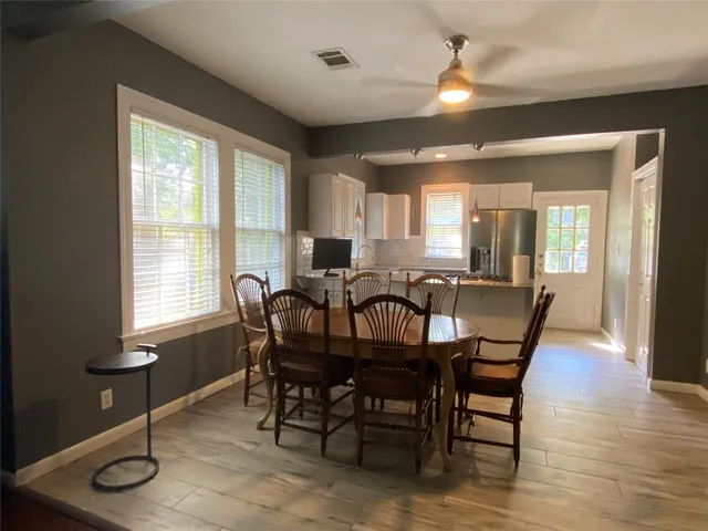 a view of a a dining room with furniture window and wooden floor
