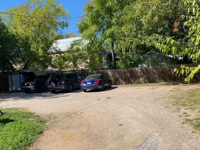 a car parked in front of a white house