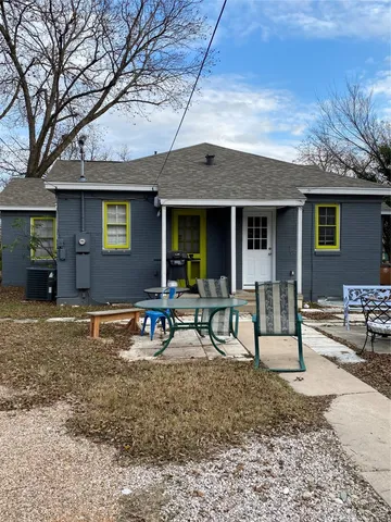 a view of a house with backyard porch and sitting area