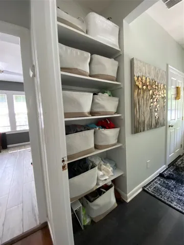 a room with wooden floor and shoes