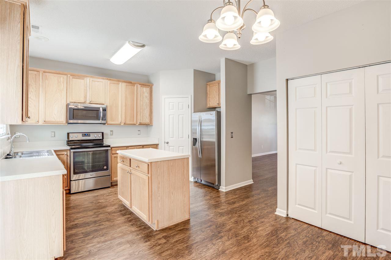 105 Watertree Lane Apex, NC 27502 - Photo 11 of 30 a kitchen with a refrigerator sink and cabinets