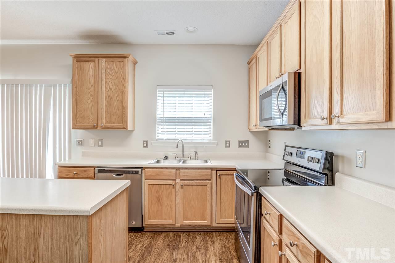 105 Watertree Lane Apex, NC 27502 - Photo 15 of 30 a kitchen with a sink stove and cabinets