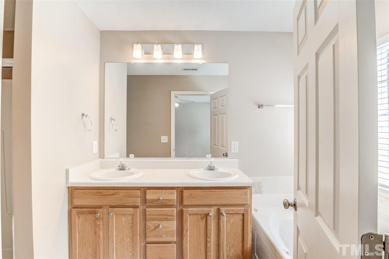 105 Watertree Lane Apex, NC 27502 - Photo 20 of 30 a bathroom with a sink double vanity and a mirror