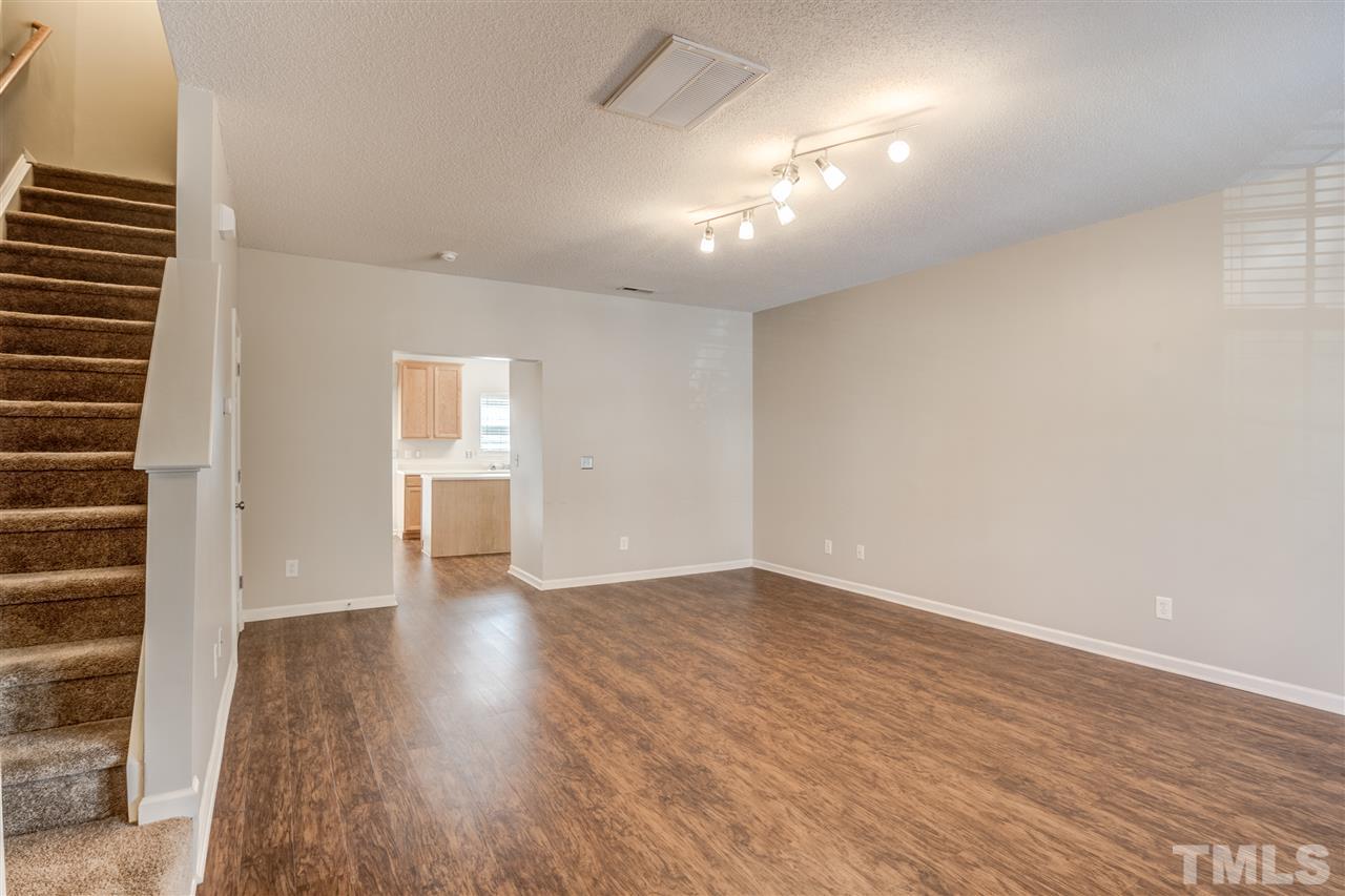 105 Watertree Lane Apex, NC 27502 - Photo 3 of 30 a view of an empty room with wooden floor and a window