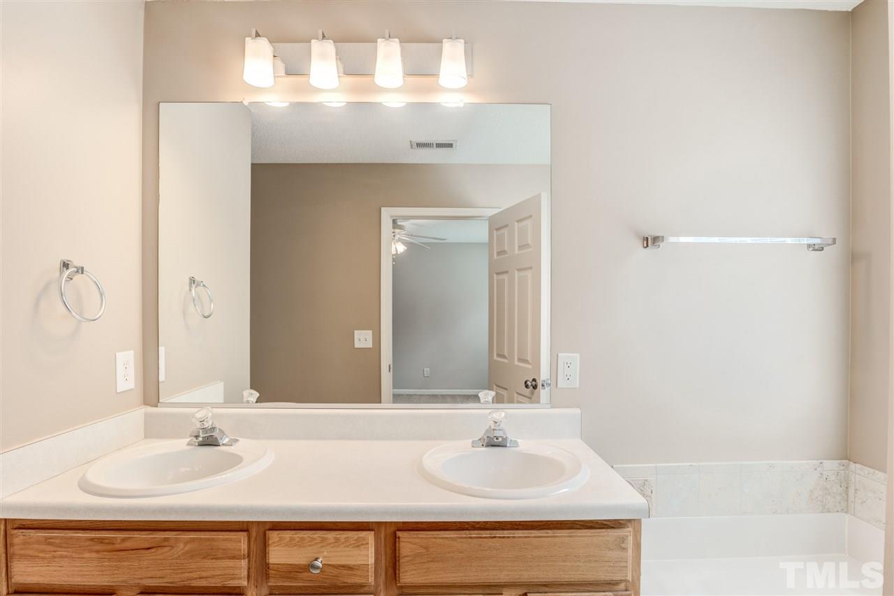 105 Watertree Lane Apex, NC 27502 - Photo 21 of 30 a bathroom with a sink and a mirror