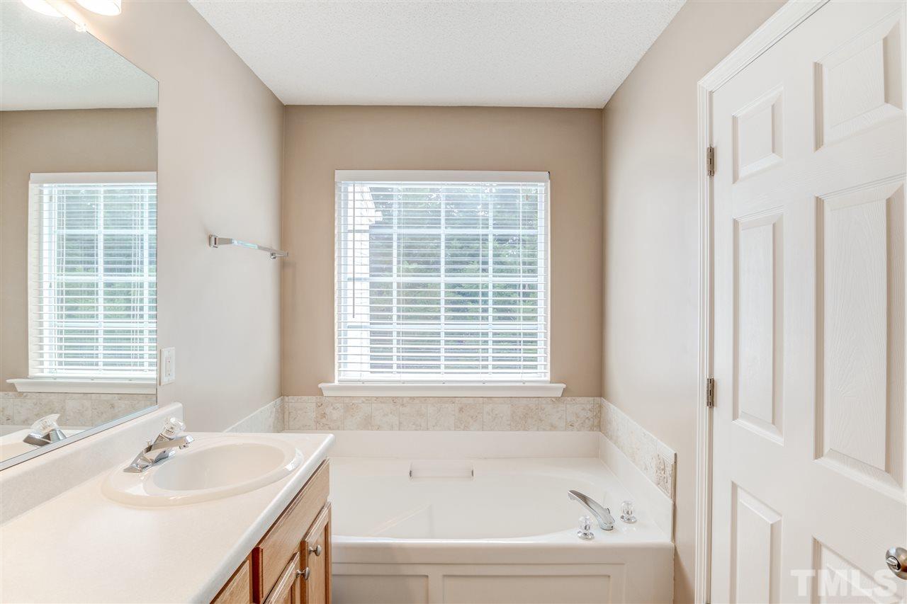 105 Watertree Lane Apex, NC 27502 - Photo 22 of 30 a bathroom with a bathtub and a sink