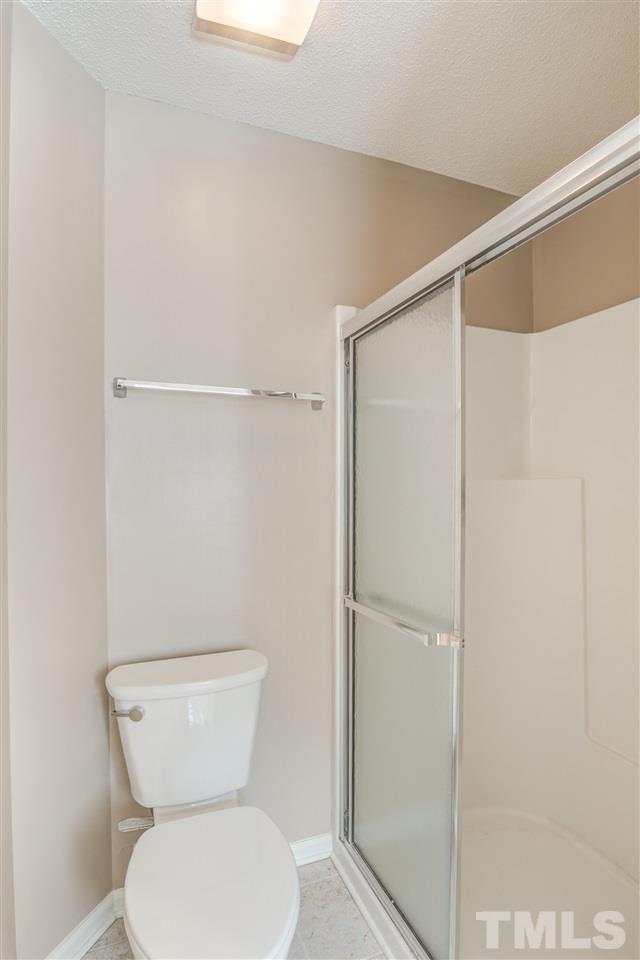 105 Watertree Lane Apex, NC 27502 - Photo 25 of 30 a bathroom with a toilet