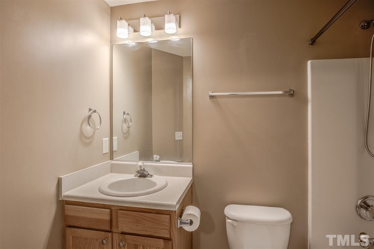 105 Watertree Lane Apex, NC 27502 - Photo 27 of 30 a bathroom with a sink toilet and a mirror