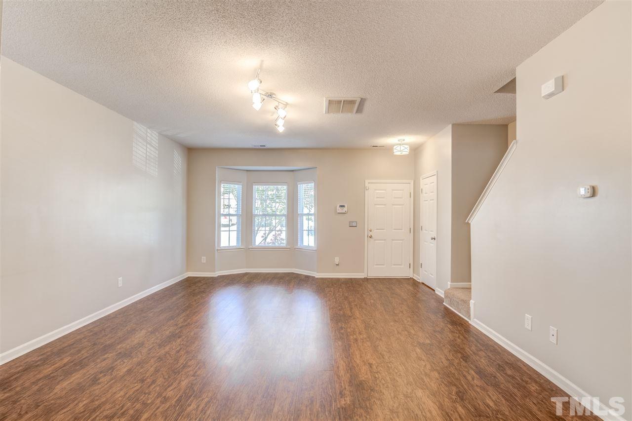 105 Watertree Lane Apex, NC 27502 - Photo 4 of 30 a view of an empty room with wooden floor and a window