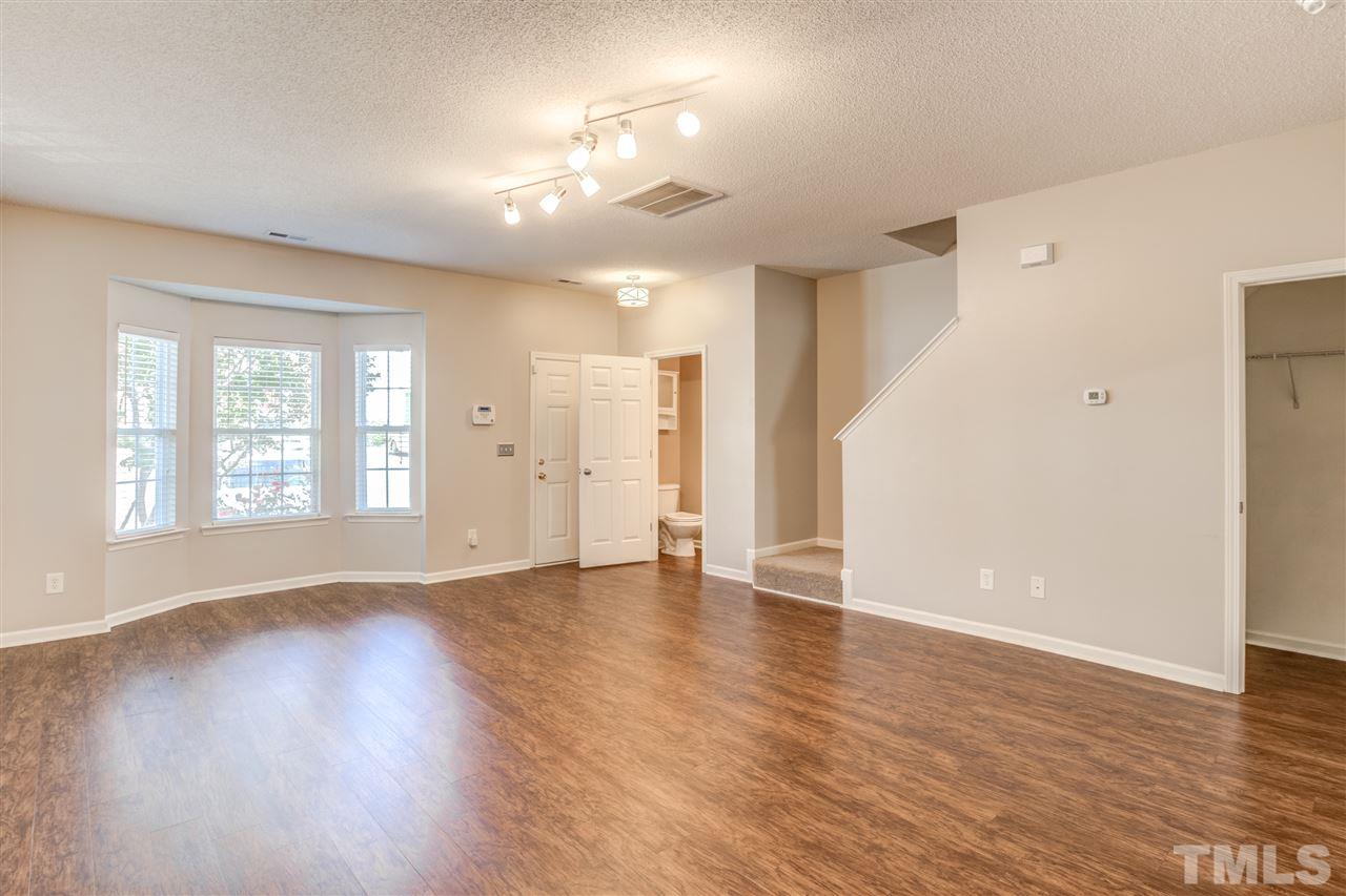 105 Watertree Lane Apex, NC 27502 - Photo 6 of 30 a view of an empty room with wooden floor and a window
