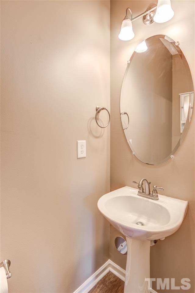 105 Watertree Lane Apex, NC 27502 - Photo 9 of 30 a bathroom with a sink and mirror