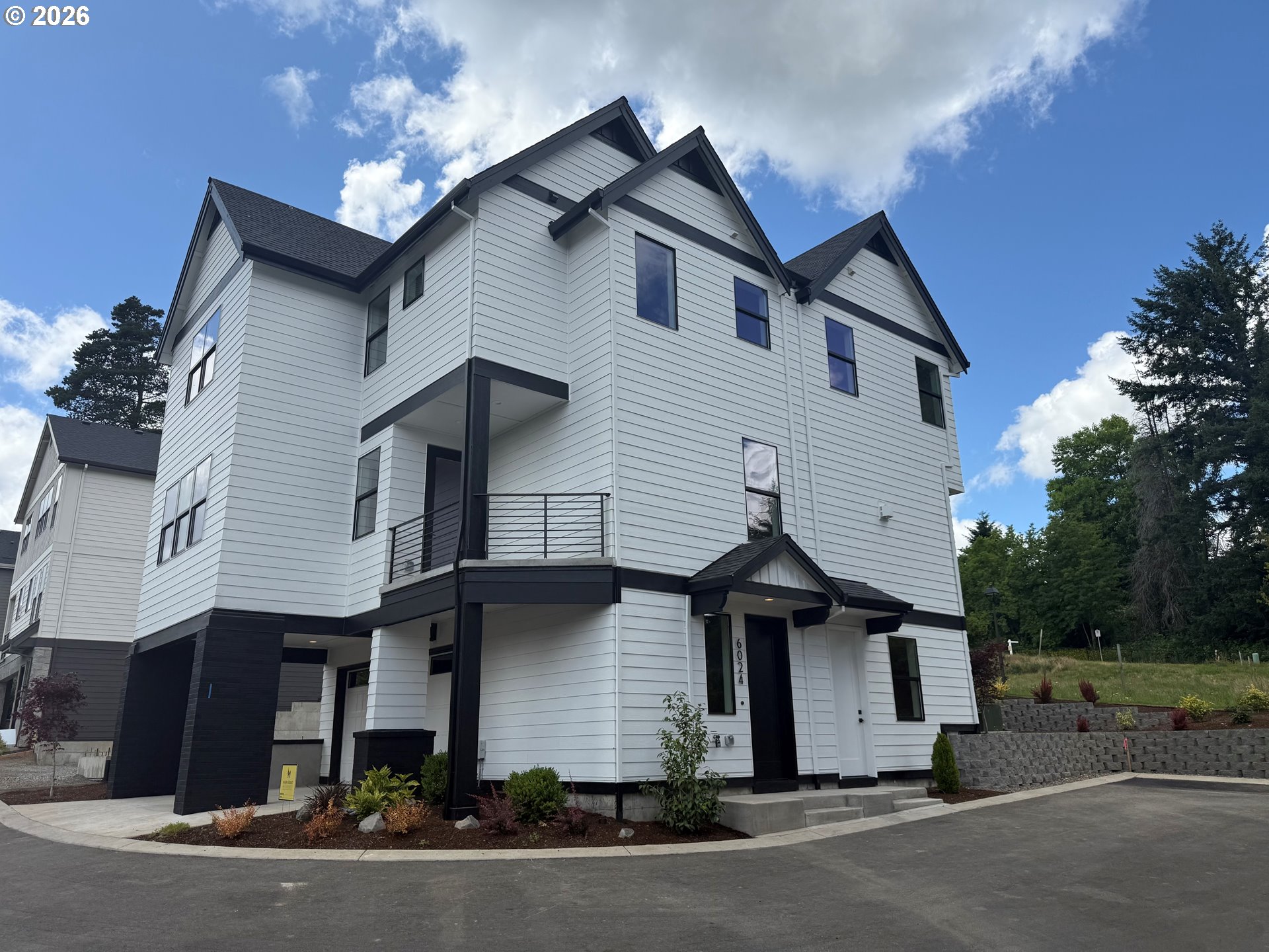 6024 Southwest 18th Drive Portland, OR 97239 - Photo 1 of 46 a front view of a house with a yard