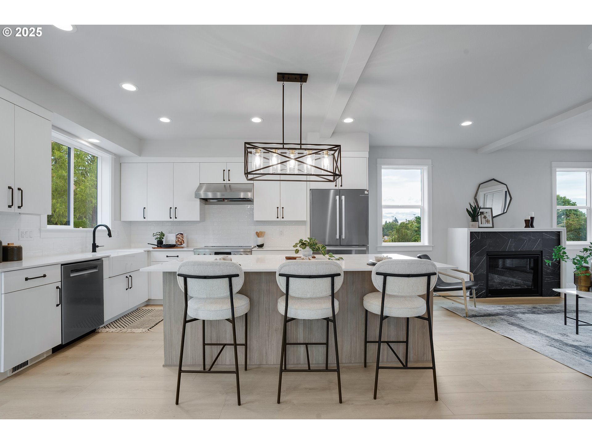 6024 Southwest 18th Drive Portland, OR 97239 - Photo 16 of 46 a kitchen with stainless steel appliances a dining table chairs and window