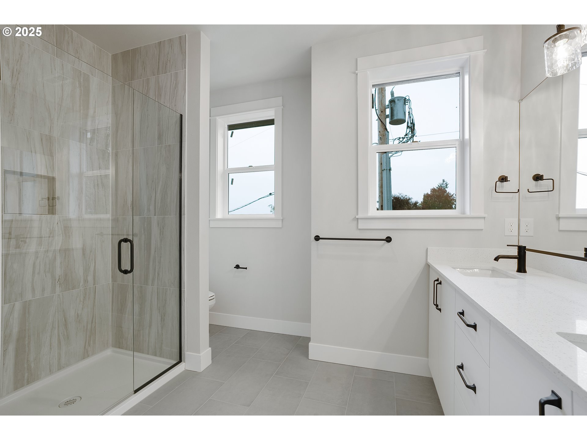6024 Southwest 18th Drive Portland, OR 97239 - Photo 41 of 46 a bathroom with a sink a mirror and next to a window